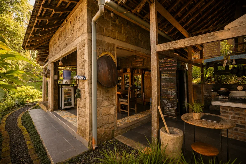 Kitchen and dining pavilion surrounded by tropical garden